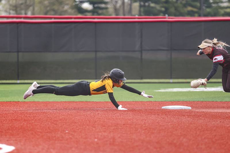Joliet West's Mackenzie Mielke (5) dives back to second after overunning the base during softball game between Joliet West at Yorkville on Wednesday, April 30, 2025 in Yorkville.