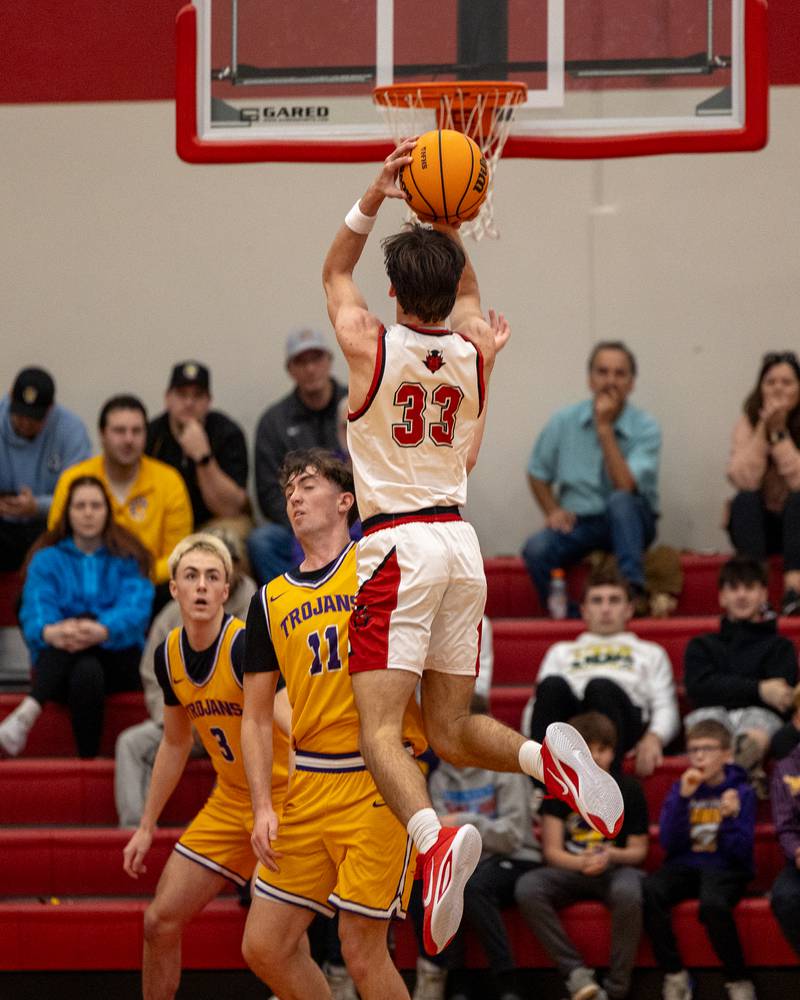 Braden Curran (33) of Hall jumps into shot as Aden Tillman (11) of Mendota braces for impact in the championship game of the Colmone Classic on Saturday, December 20, 2025 at Hall High School in Spring Valley.