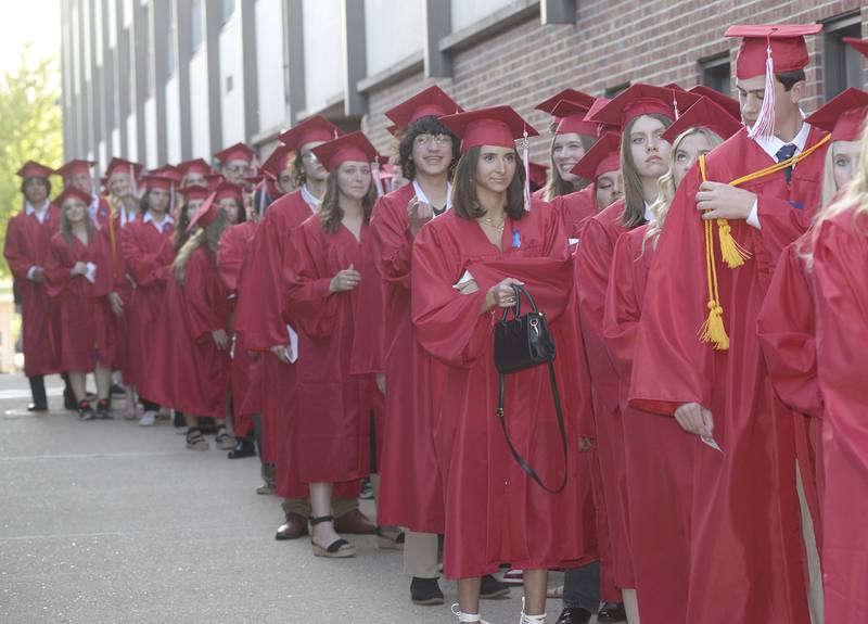 The Class of 2023 lines up and waits to enter King Field on Friday, May 26, 2023, during graduation ceremony at Ottawa High School.
