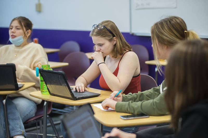 Abby Tate pulls up the laptop in her publications class at Dixon High School to research a current news event on Friday, April 22, 2022.