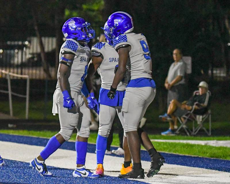 St. Francis DeShaun Williams (9) celebrates with teammates after scoring a touchdown in the second quarter while taking on Joliet Catholic Academy held at St. Francis High School in Wheaton on Friday Sep. 22, 2023.