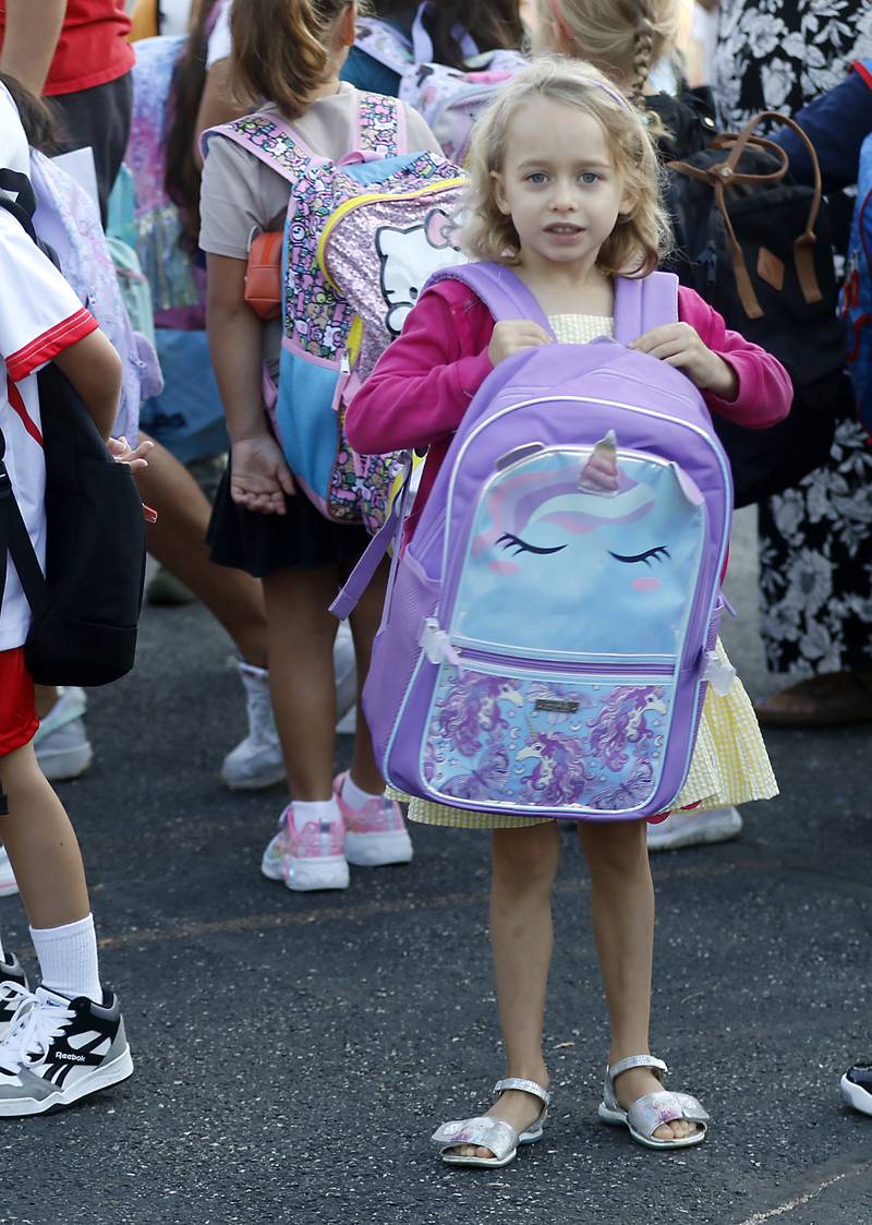 First-grader River Radclift waits for school to start with other students on the first day of school at Olson Elementary School in Woodstock on Wednesday, Aug. 14, 2024,