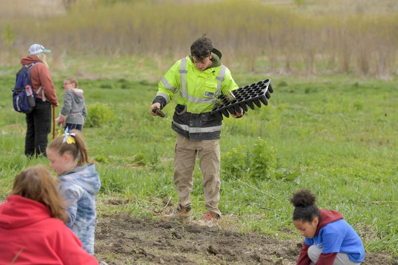 Volunteers plant native prairie plants at Peck Farm’s Dolomite Prairie as part of Geneva’s Earth Day Celebration on Saturday, April 20, 2024.