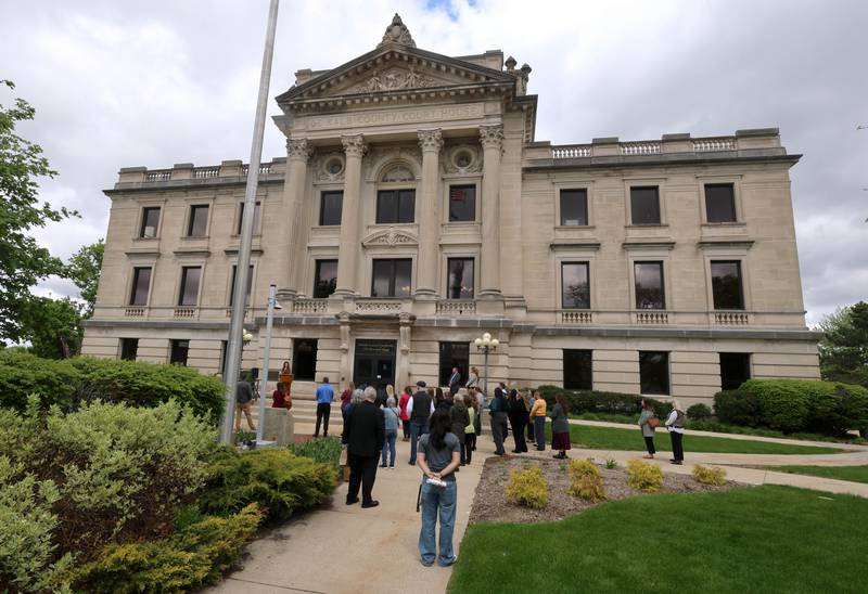 Attendees listen to speakers Wednesday, April 29, 2026, during Hands Around the Courthouse at the DeKalb County Courthouse in Sycamore. The event was held to mark Child Abuse Prevention Month.