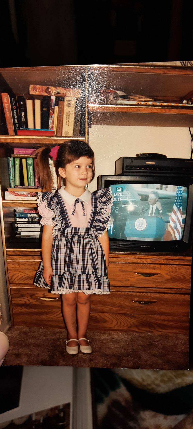 A young Karina Maksimova stands next to a television airing a message by then President Bill Clinton in the 1990s after her family immigrated from Ukraine to the United States. Maksimova spoke with the Daily Chronicle Thursday, Feb. 24, 2022 after Russia invaded Ukraine and shared her fears for her family, much of whom still live in the eastern European country.