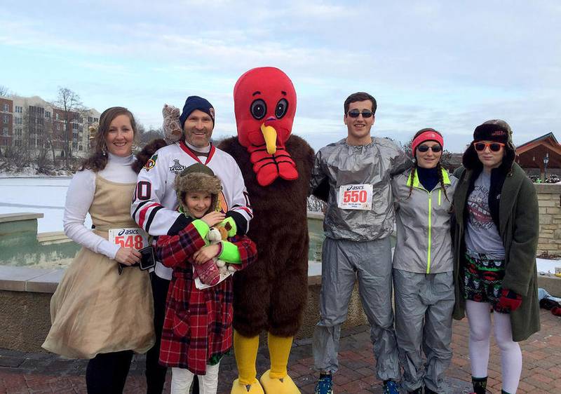 The Ball family of Batavia, including mother Ellen (left), father Jeff and children Katherine, William, Grace and Bridget pose in 2014 with a turkey mascot at The Fox and The Turkey Races in Batavia. The family has run in the races since at least 2009.