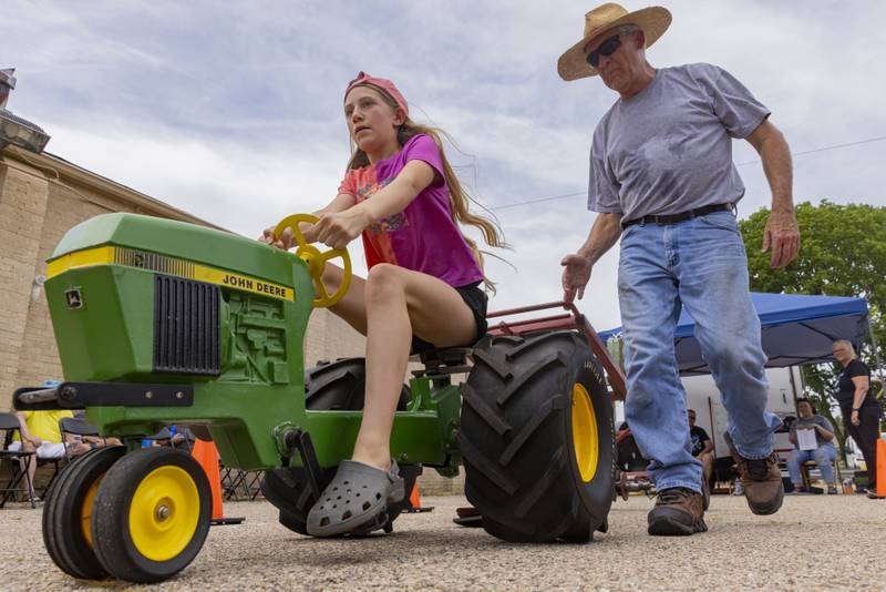 Elizabeth Keutzer pedals down the track at the kiddie tractor pull Saturday, June 15, 2024, during Beef and Ag Days at Soldiers and Sailors Park in Princeton.