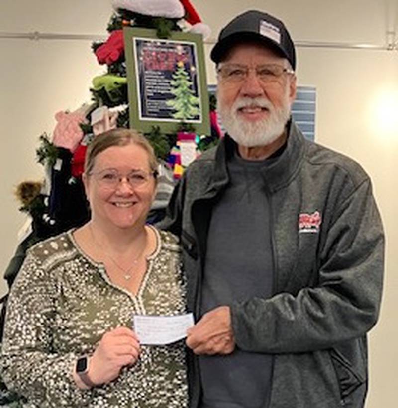 Yorkville Lion Ken Johnson presented the Yorkville Public Library's annual donation. Other Kendall County organizations received donations.