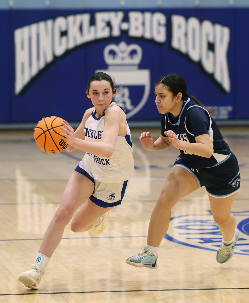 Hinckley-Big Rock's Mia Cotton drives by Illinois Math and Science Academy's Ana Ramirez during their game Thursday, Jan. 8, 2025, at Hinckley-Big Rock High School.