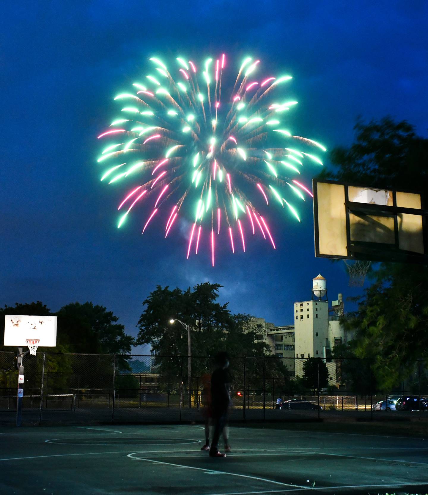 Red and green fireworks light up the sky at the conclusion of the 2024 Juneteenth Freedom Festival at Pioneer Park in Kankakee.