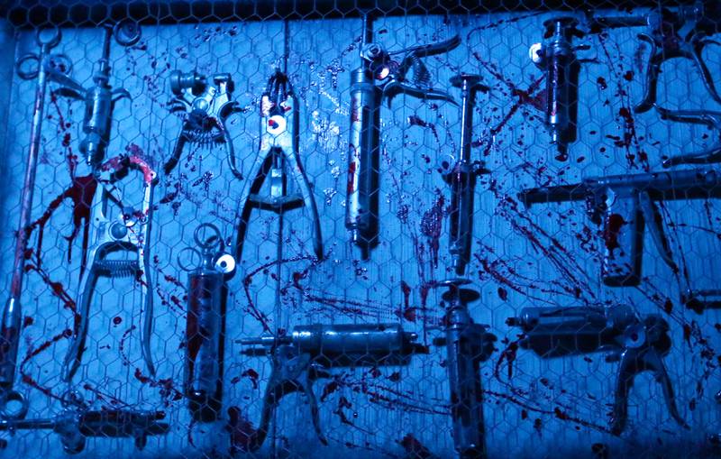 Medical tools covered in fake blood cover a wall in the Insanity Haunted House at the Peru Mall on Monday Sep. 27, 2021.