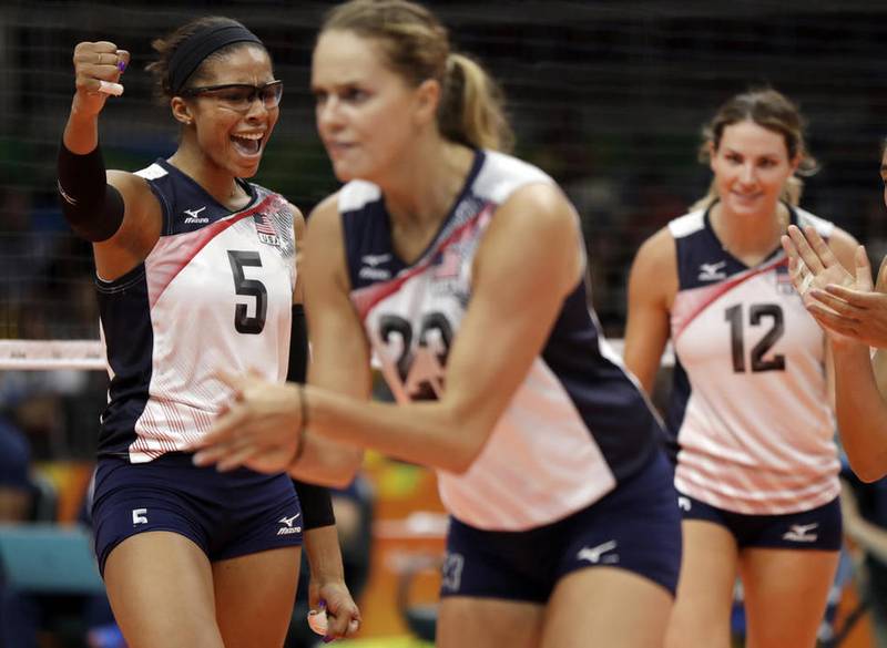 United States' Rachael Adams, left, Kelsey Robinson, center, and Joliet Catholic graduate Kelly Murphy, right, celebrate during a women's pool-play volleyball match against Puerto Rico at the Summer Olympics in Rio de Janeiro, Brazil, Saturday, Aug. 6, 2016. (AP Photo/Matt Rourke)