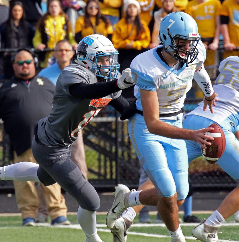 Willowbrook linebacker Tommy Iozzo grabs Maine West quarterback Danny Kentgen during an Class 7A second-round playoff game Nov. 3 in Villa Park.