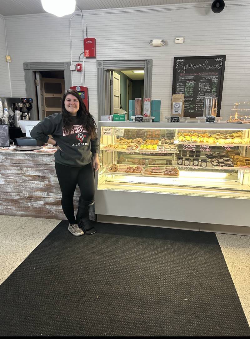 Megan DiCaro stands next to the  bakery case inside her Springview Sweets bakery.