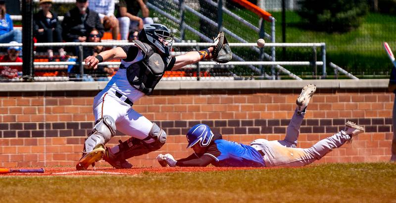 St. Charles North's Aidan O'Connell (3) slides into home beating the throw to St. Charles East's Al Gaca (12) during a baseball game at St. Charles East High School on Saturday, May 7, 2022.