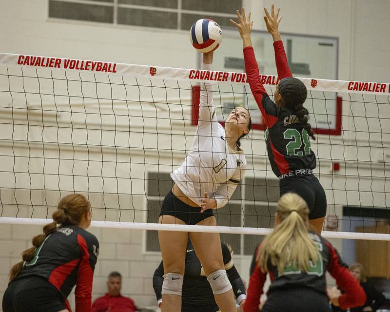 Grace Lichtardt sets up a scoring spike against Ava Currie (28) of LaSalle-Peru in an away game on September 14, 2023.
