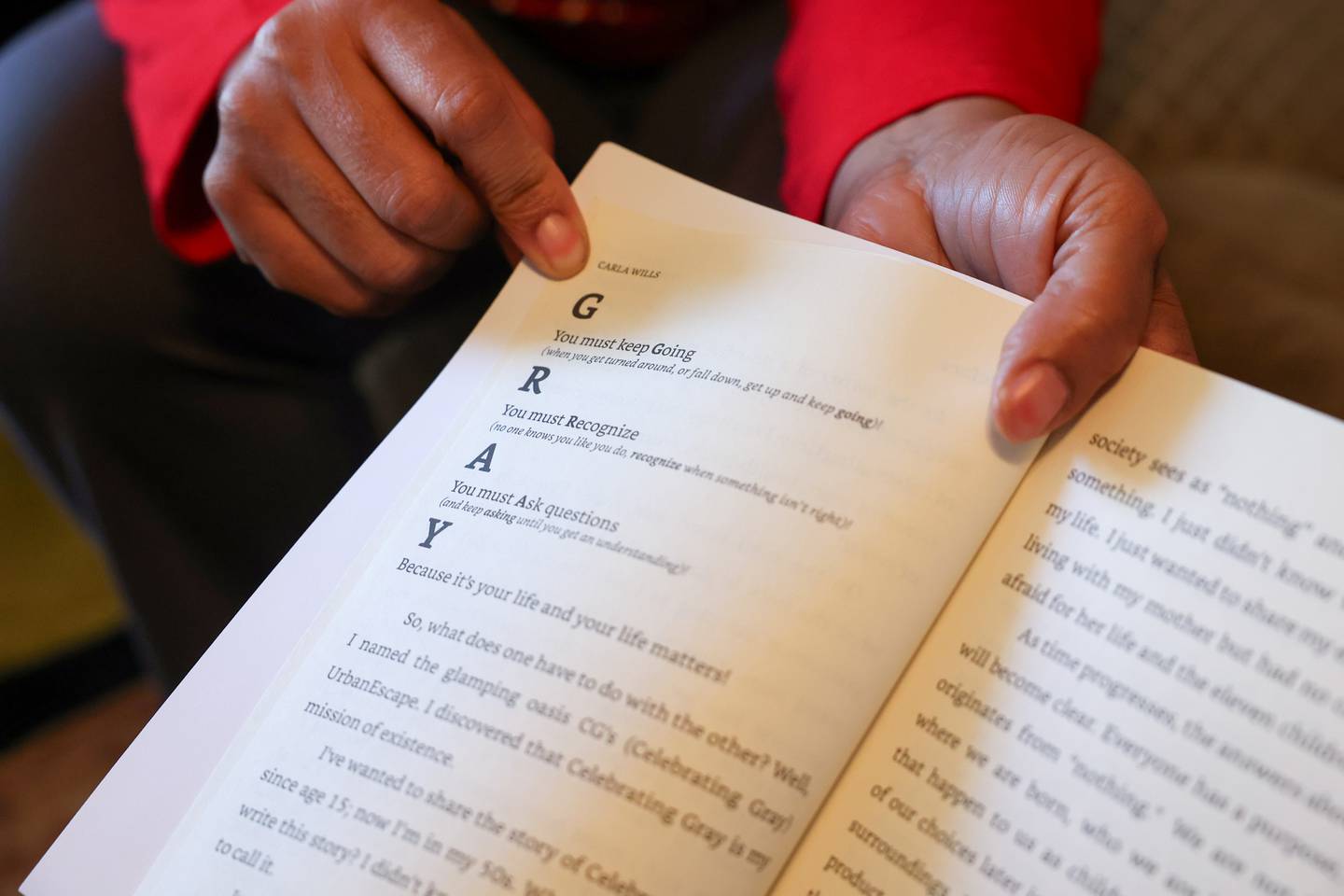 Carla Wills shares a page from the book she wrote and self-published, titled “Celebrating Gray: Having the Audacity to in spite of,” that defines the mantra she has come to live her life by.