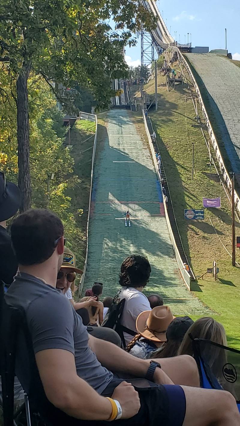 Skiers - all in their teens - take a turn on the 40-foot ski jump slope on Saturday, Oct. 4, 2025, at Fox River Grove Norge Ski Club. The annual Jumptoberfest brought ski jumpers from around the country, jumping in 80-degree weather.