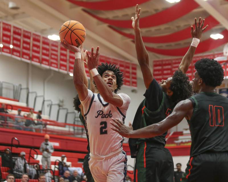 Oswego East's Jacsen Tucker (2) puts up a shot during their Hinsdale Central Holiday Classic basketball game between Morgan Park at Oswego East Saturday, Dec 27, 2025 in Hinsdale.