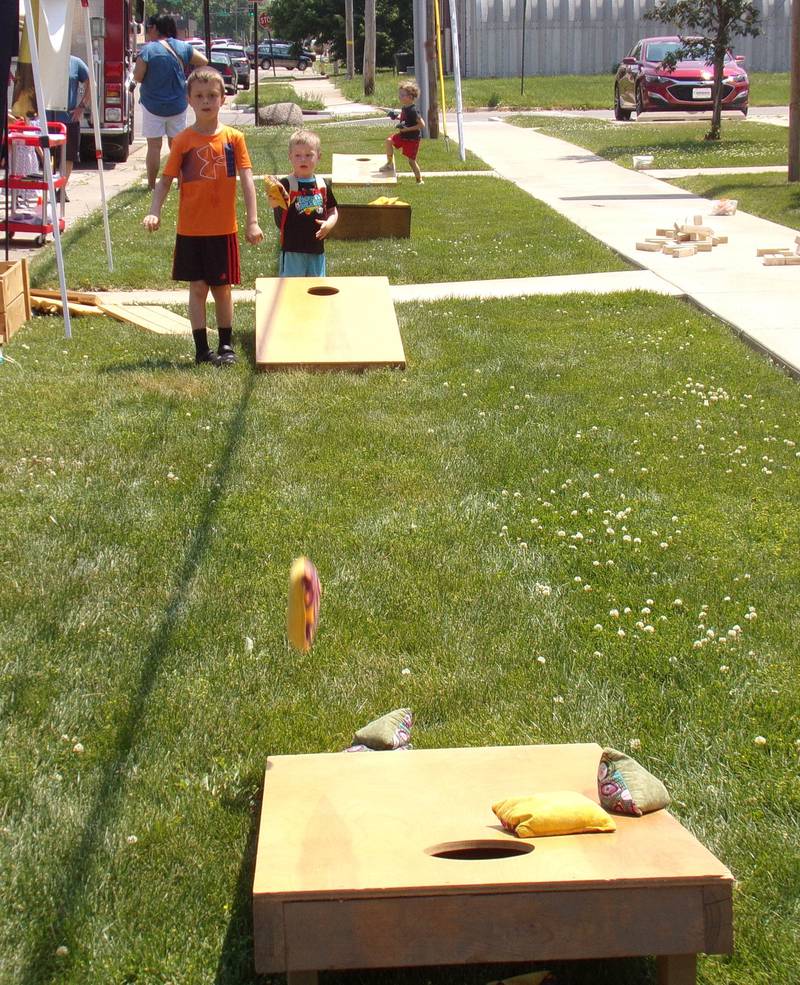 Children tossed bags Saturday, June 3, 2023, during the Summer Reading Kick-Off Party at Reddick Library in Ottawa.