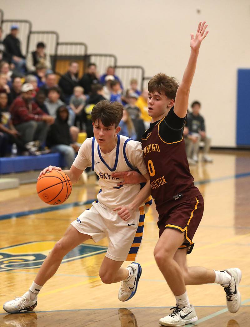 Johnsburg's Trey Toussaint drives to the basket against Richmond-Burton's Gavin Radmer during the IHSA Class 2A Johnsburg Regional Championship boys basketball game on Friday, February, 27, 2026, at Johnsburg High School.