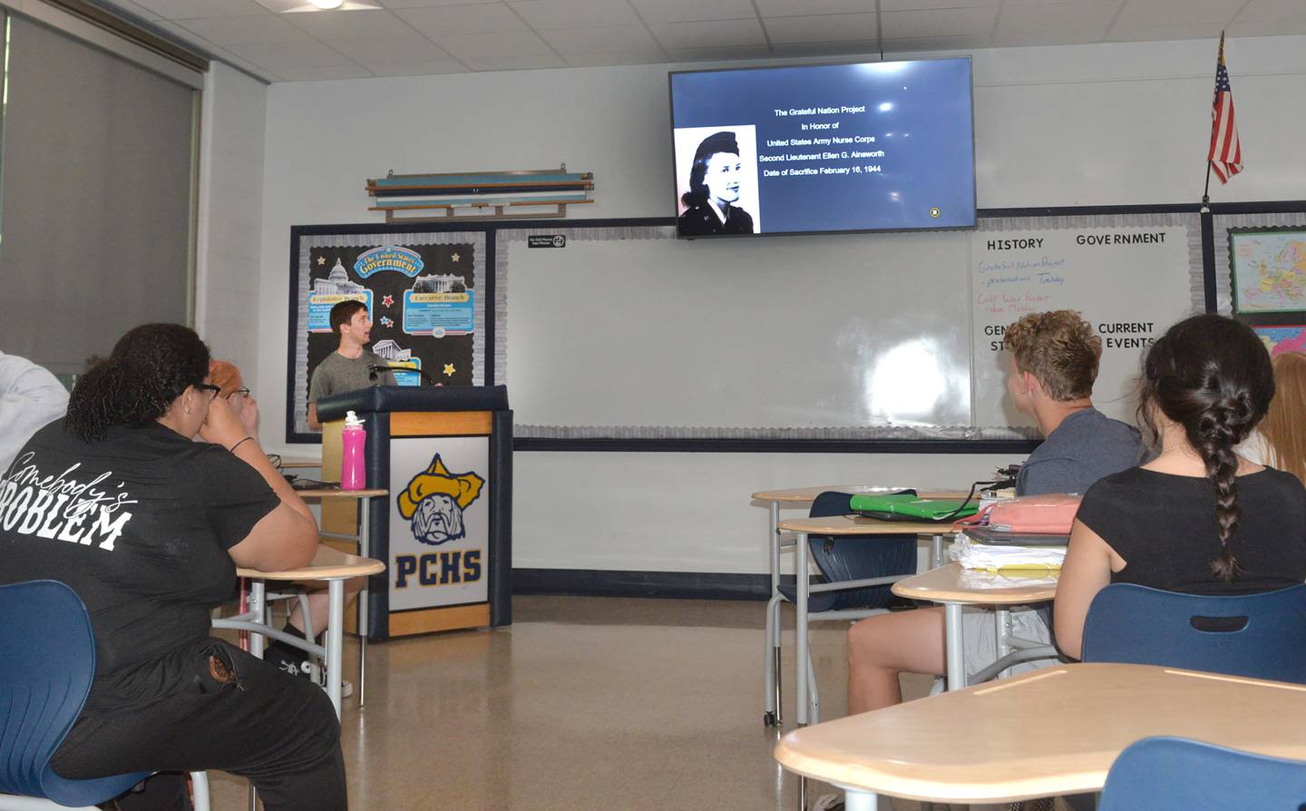 Polo High School Junior Joe Rowland (left), gives his presentation Thursday, May 15, 2025 about Ellen Ainsworth, an Army nurse who died after refusing to leave her patients in Italy in 1944.