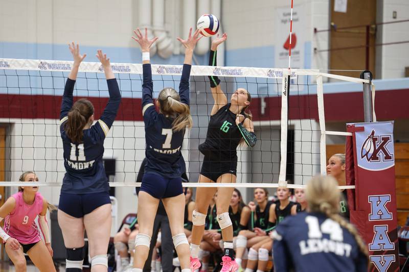Providence's Cali Tierney spikes the ball against Lemont's Colleen Arundel (11) and Fiona Tkach during Providence's victory in two sets, 25-25, 25-18, over Lemont in the IHSA Class 3A Kankakee Sectional championship on Thursday, Nov. 6, 2025.
