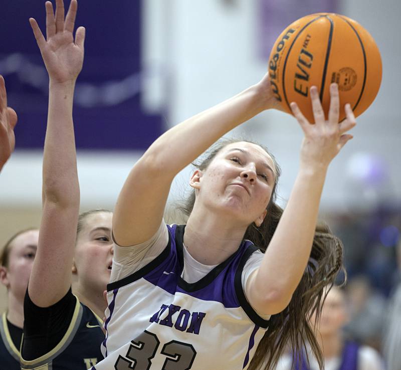 Dixon’s Lucy Feick hauls in a rebound against Harvest-Westminster Wednesday, Feb. 11, 2026.