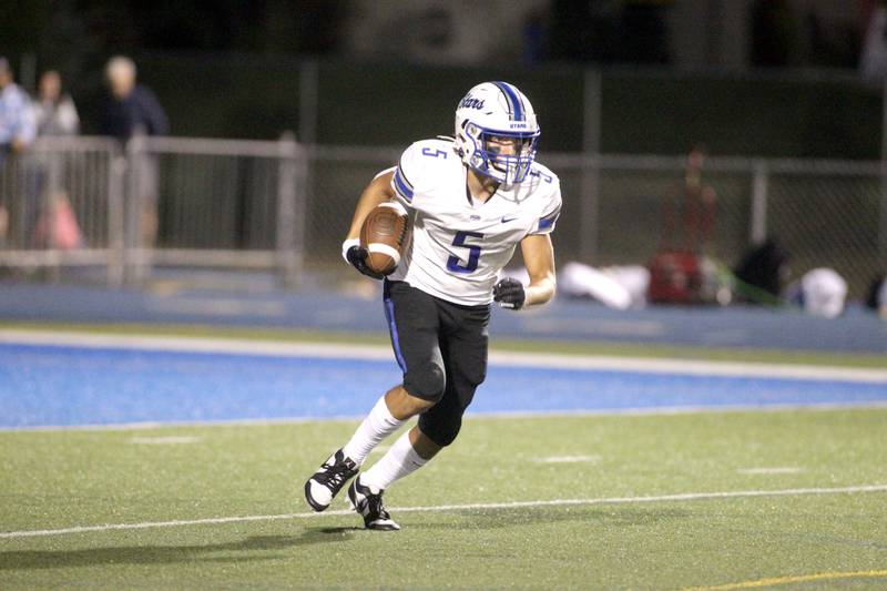 St. Charles North’s Anthony Taormina returns a kick-off during a game at Wheaton North on Friday, Sept. 8, 2023.
