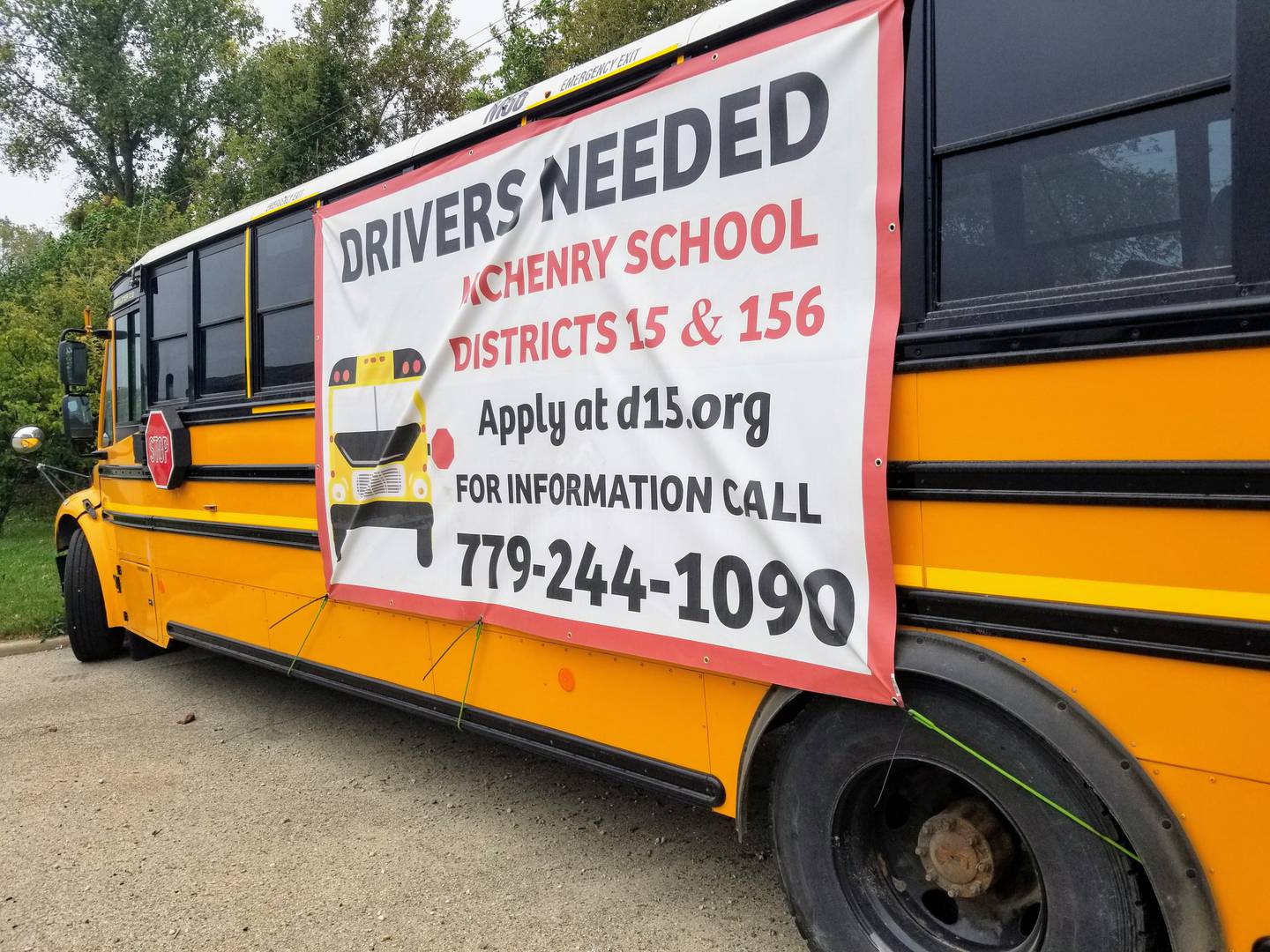 A banner advertising bus driver positions available with McHenry-based school districts is displayed along Route 120 in McHenry on Wednesday, Oct. 6, 2021.