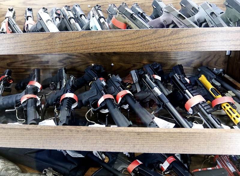 Red tagged 22 caller firearms that can no longer sold at Second Amendment Sports, in McHenry, Wednesday Jan. 11, 2023, after a new gun law restricting a number of firearms and attachments and limiting ammunition was signed into law Tuesday night by Gov. JB Pritzker. The bill, along with requiring registration for such guns if already owned and enhancing gun restraining orders, hits at semiautomatic weapons.