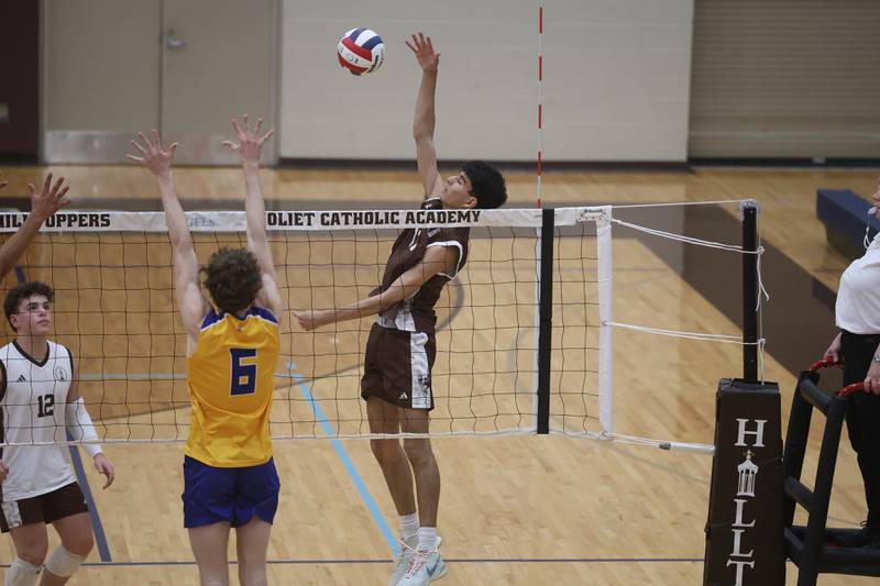 Joliet Catholic’s Aydan Garcia hits a shot against Joliet Central on Wednesday, April 1, 2026 in Joliet.