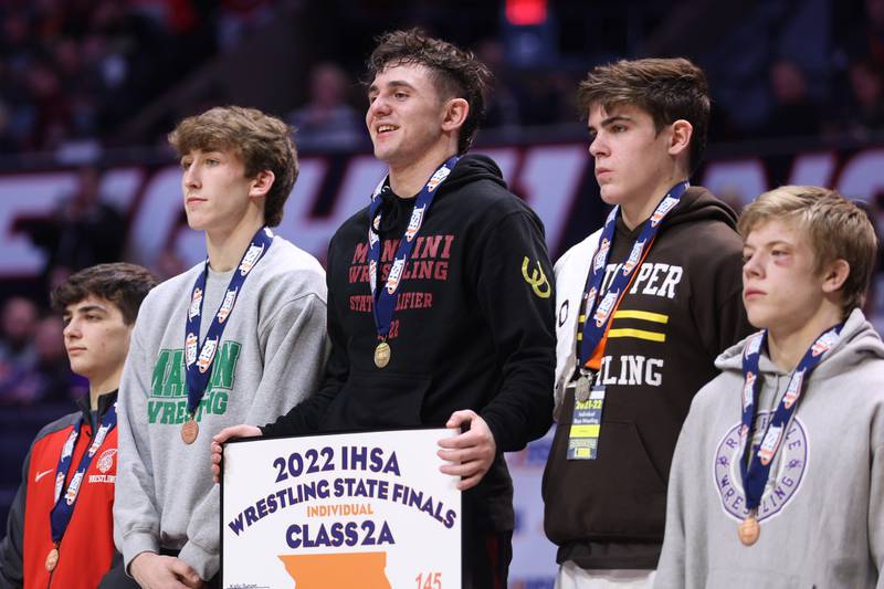 Montini’s Jayden Colon takes the podium as the Class 2A 145lb. champion at State Farm Center in Champaign. Saturday, Feb. 19, 2022, in Champaign.