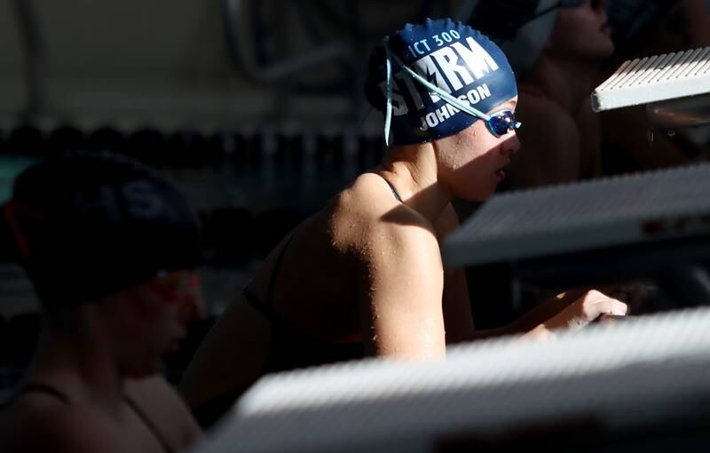 Rachel Johnson of Dundee-Crown co-op prepares to launch into the 100-yard backstroke during the Fox Valley Conference Championship Meet at Woodstock North High School on Saturday, Nov. 2, 2024 in Woodstock .