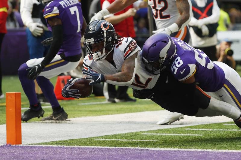 Chicago Bears wide receiver Velus Jones Jr. scores on a 9-yard touchdown reception ahead of Minnesota Vikings linebacker Jordan Hicks during the second half, Sunday, Oct. 9, 2022, in Minneapolis.