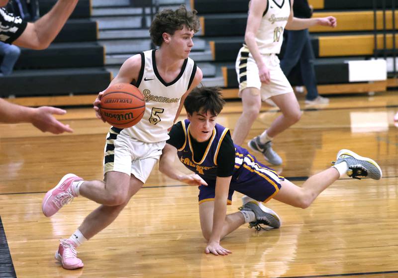 Sycamore's Preston Picolotti gets by Mendota's Cale Strouss during their game Wednesday, Dec. 13, 2023, at Sycamore High School.