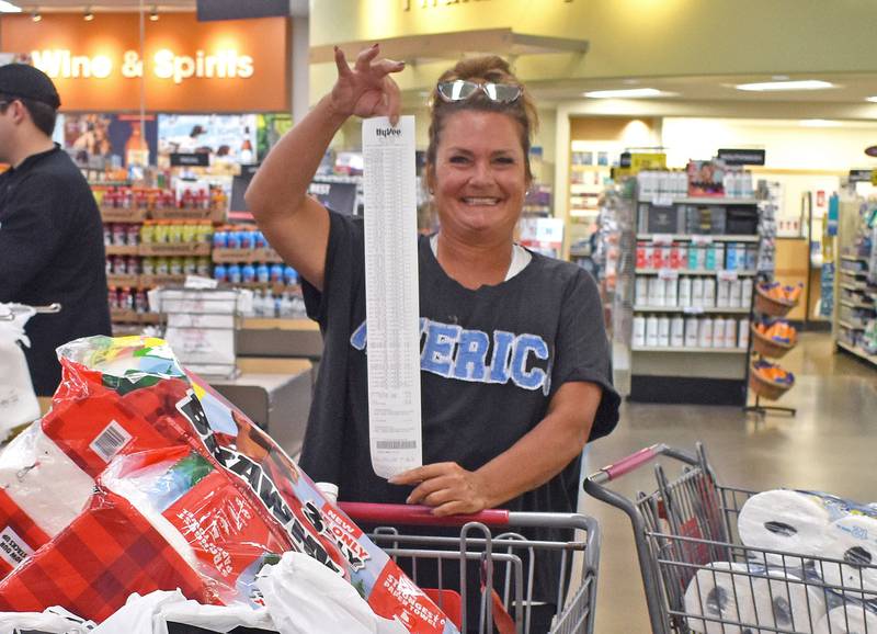 Michelle Duttlinger of Ottawa, holds her receipt after checking out during the Hometown National Bank “Hometown Hero” sweepstakes on Friday, Aug. 23, 2025 at Hy-Vee in Peru. Duttlinger was the winner of the shopping spree.