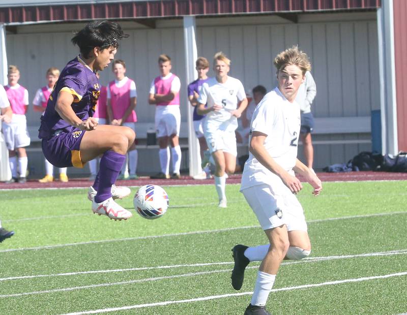 Mendota's Alex Beetz leaps in the air to gain control of the ball while Quincy Notre Dame's Angel Orozco defends during the Class 1A Sectional semifinal game on Saturday, Oct. 21, 2023 at Illinois Valley Central High School in Chillicothe.