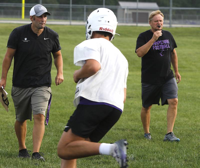 Hampshire football head coach Shane Haak and assistant coach Tim Haak watch a play during the first day of football practice Monday, August 7, 2023, at Hampshire High School.