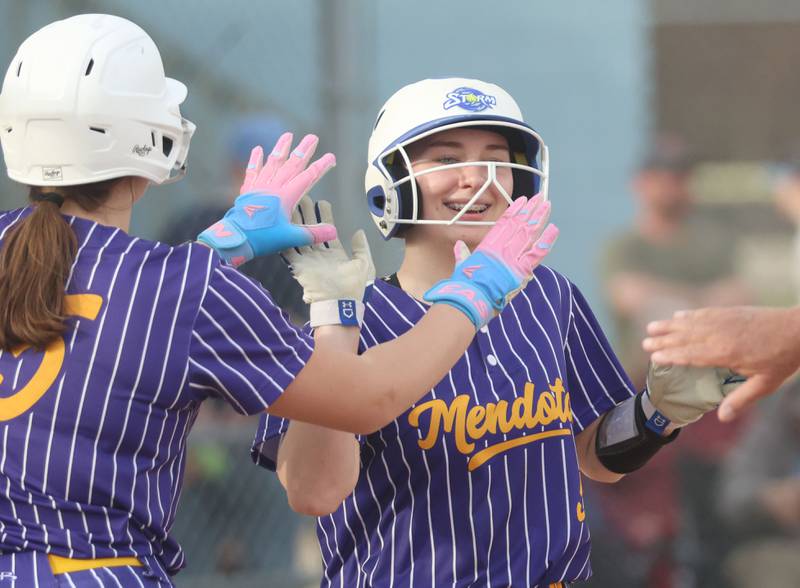 Mendota's Lexie Saylor hi-fives teammate Charlie Dankenbring after scoring a run against Marquette on Wednesday, March 25, 2026 at June Gross Field in Ottawa.