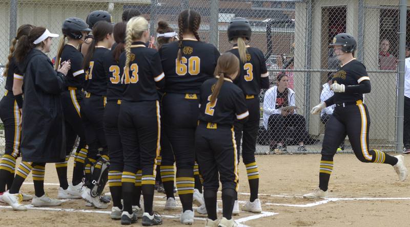 Reed Custer’s Grace Cavanaugh is greeted by her team mates at home plate after hitting a 1st inning home run Friday against Ottawa.