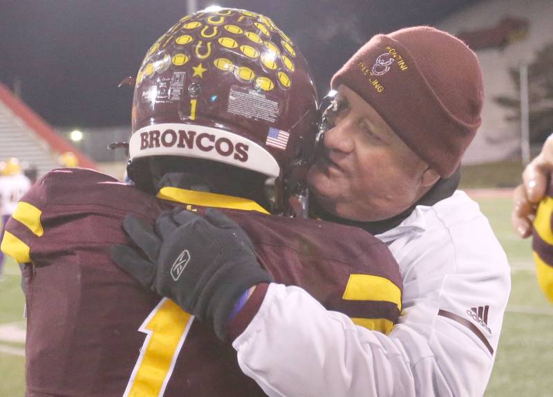 Montini Catholic head coach Mike Bukovsky hugs player Santino Florio after winning  the Class 3A State football championship on Friday, Nov. 29, 2024 at Hancock Stadium in Normal.
