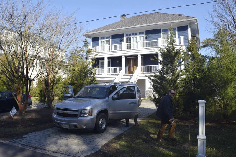 FILE - U.S. Secret Service agents are seen in front of Joe Biden's Rehoboth Beach, Del., home on Jan. 12, 2021. The FBI is conducting a planned search of President Joe Biden’s Rehoboth Beach, Delaware home as part of its investigation into the potential mishandling of classified documents. That's according to a statement from Biden's personal lawyer. (Shannon McNaught/Delaware News Journal via AP, File)