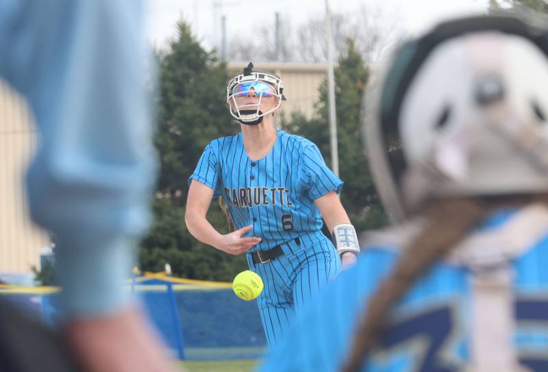 Marquette head softball coach Brian McCallum talks to his team between innings while playing Mendota on Wednesday, March 25, 2026 at June Gross Field in Ottawa.