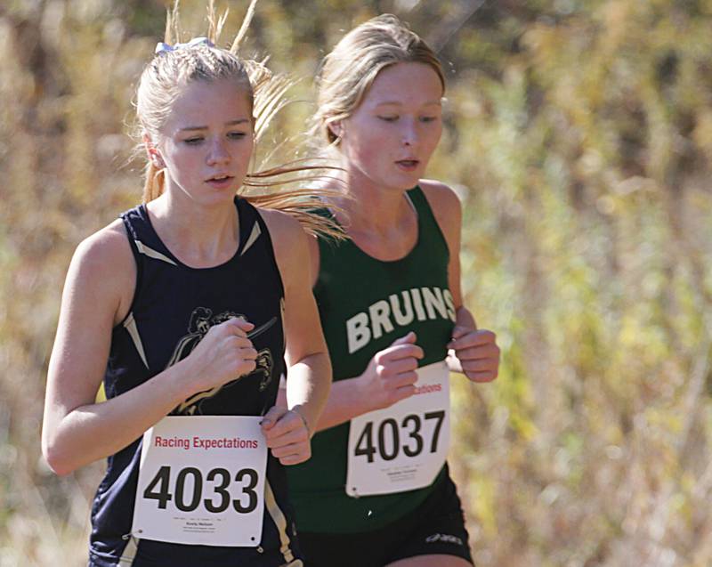 Marquette's Keely Nelson and St. Bede's Madelyn Torrance run in the Class 1A Regional Cross Country gils race on Saturday, Oct. 22, 2022 at the Seneca FFA Farm in Marseilles.