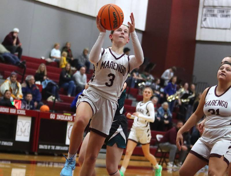 Marengo’s Maggie Hanson lays the ball up against Woodstock North in varsity girls basketball on Tuesday, Dec. 2, 2025, at Marengo High School in Marengo.