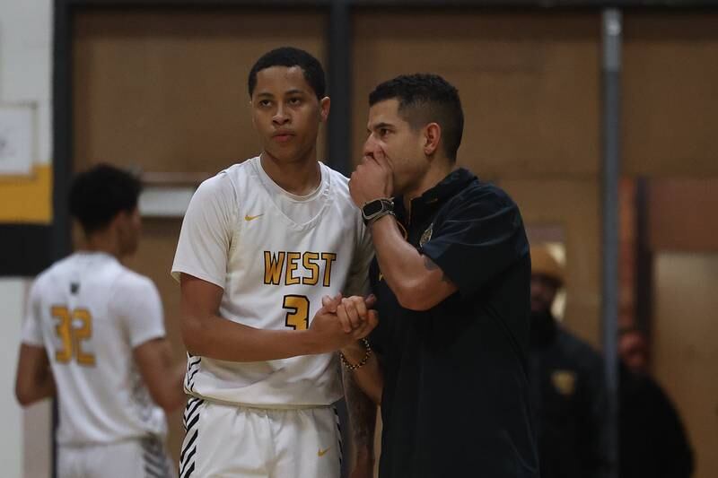 Joliet West head coach Jeremy Kreiger talks to Tristian Saunders against Bolingbrook on Friday, Jan 24, 2025 in Joliet.