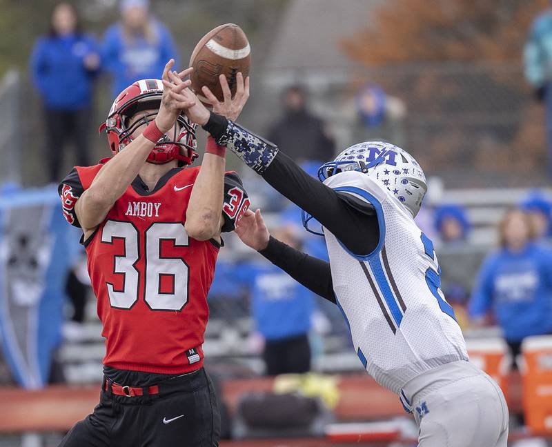 Amboy’s Caleb Yanos has a catch knocked away by Martinsville’s Kaiden Simons Saturday, Nov. 9, 2024, in round two of the 8-man football playoffs.
