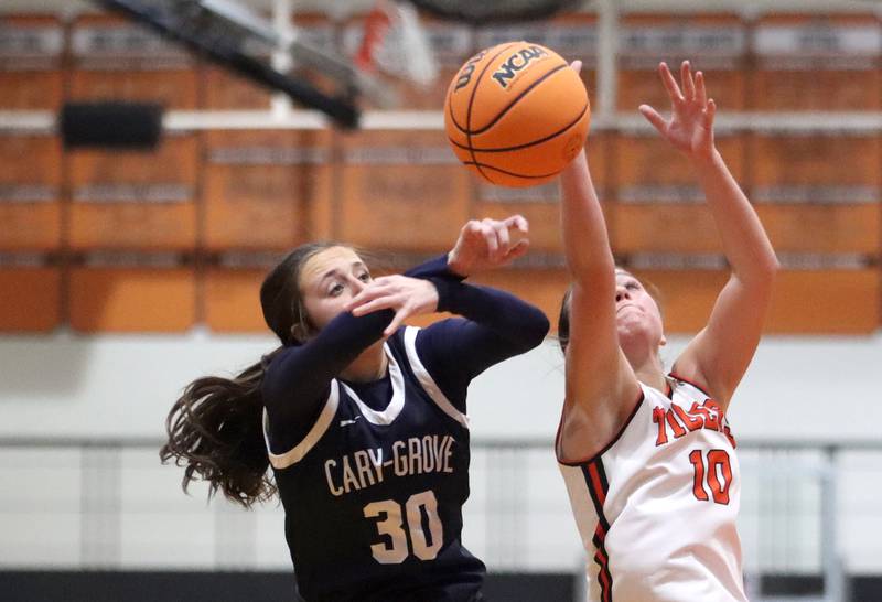 Cary-Grove’s Samantha Skerl, left, battles Crystal Lake Central’s Samantha Pottorff for the ball  in varsity girls basketball on Tuesday, Jan. 7, 2025, at Crystal Lake Central High School in Crystal Lake.