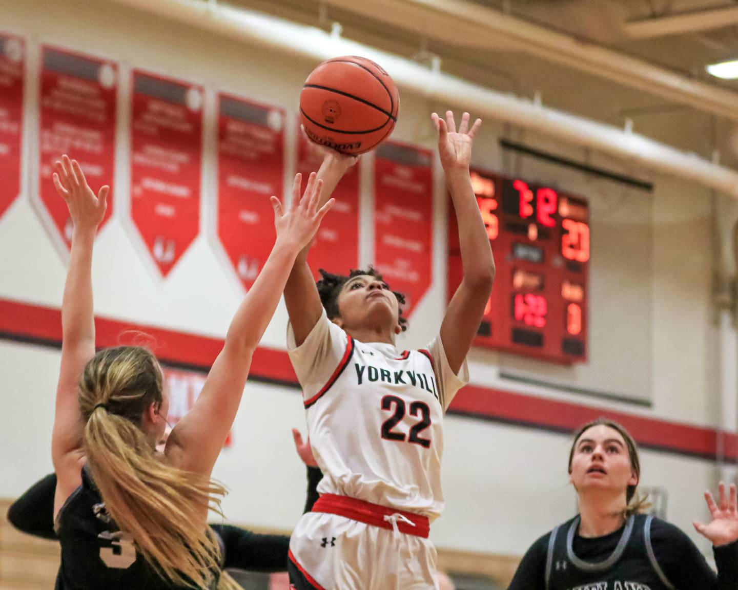 Yorkville's Alex Stewart (22) puts up a shot in the paint during varsity basketball game between Kaneland at Yorkville. Dec 14, 2022.